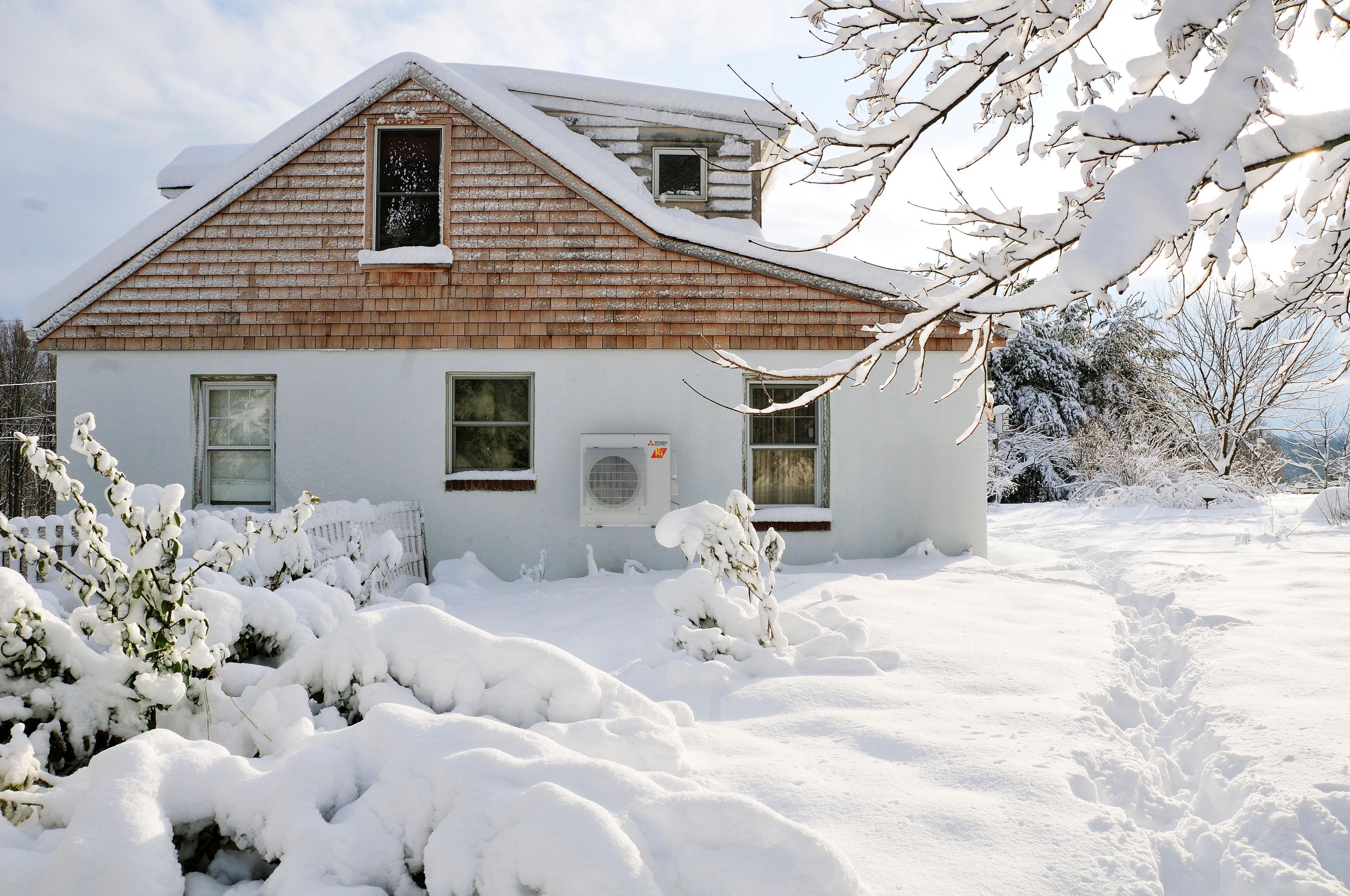 Heat pump heating home in deep snow and wintery conditions