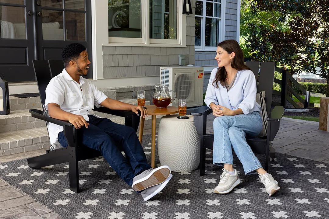 Couple enjoying quiet outdoor space with heat pump in operation