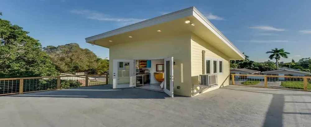 Tiny Surf House home house garage architecture door driveway family luxury window daylight building street roof gas station porch entrance suburb spacious parking lot