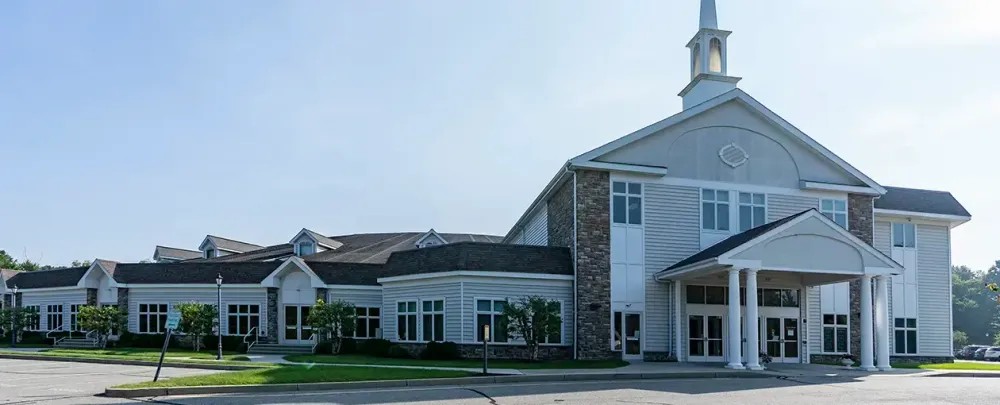 Walnut Hill Community Church architecture home house building roof garage driveway luxury family facade window sky outdoors suburban lawn suburb realty yard porch